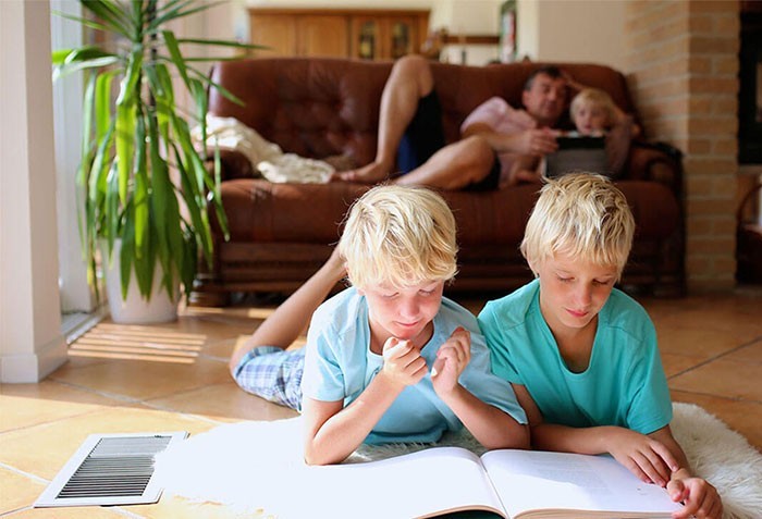 Brothers reading on tile floor | Leon Country Floors & More